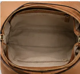 Open brown purse with clean interior left empty so the lining can air-dry completely