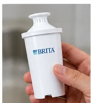 A clean replacement Brita-style filter cartridge held in one hand before installation.