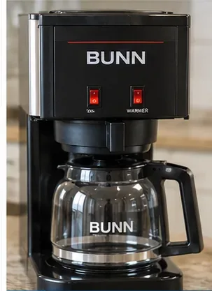 Clean black BUNN-style coffee maker reassembled with an empty glass carafe in place