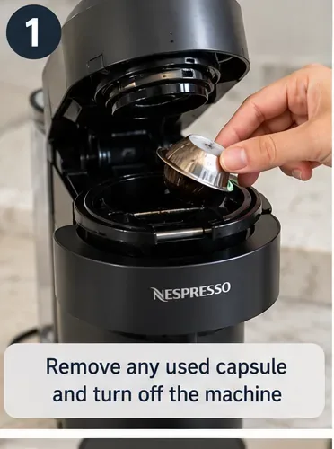 A used Vertuo capsule being removed from the open machine head before the machine is turned off for manual cleaning