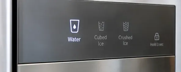 A refrigerator dispenser control panel with Water selected and a lock icon visible before cleaning.